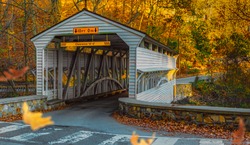 The Knox Covered Bridge at Valley Forge National Park Historical Park in Autumn With Leaves Falling Through the Image