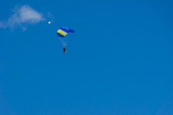 tandem parachute jump, a beginner with an instructor land under the canopy of a parachute