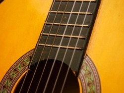 Classical guitar strings and frets close up shot selective focus