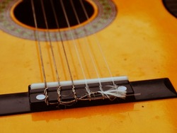 Classical guitar strings and frets medium shot zoom selective focus