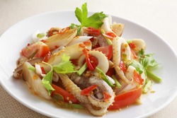close up thai spicy seafood salad in ceramic dish