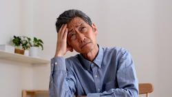 Senior man suffering from troubled face