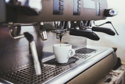 Close-up of an espresso machine making a cup of coffee.