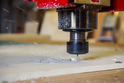 CNC cutter machine in action, cuting off plastic material