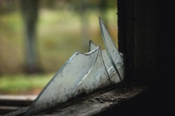 Dirty and broken glass, broken window. Abandoned house. Poverty, scary interior. Selective focus