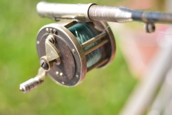 Close up of fishing rod wheel gear, selective focusing