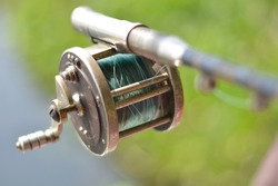 Close up of fishing rod wheel gear, selective focusing