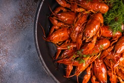 A pile of tasty boiled crawfish. Boiled red crayfish or crawfish with  herbs on a table. Crayfish party, restaurant, cafe, pub menu.