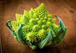 Romanesco broccoli, or Roman cauliflower on wooden table
