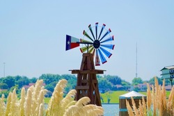 Texas flag windmill in the fall on a lake in Dallas Fort Worth Texas             