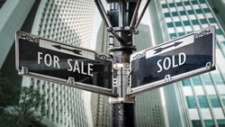 Street Sign the Direction Way to SOLD versus FOR SALE