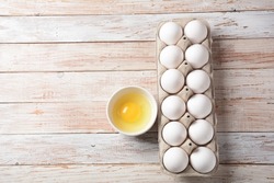 White eggs and egg yolk .Store bought chicken eggs in gray carton