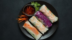Vietnamese Spring Rolls Goi Cuon or Nem Cuon,  filled with prawns, herbs, rice vermicelli and vegetables. Served with hoisin and peanut sauce dip. 