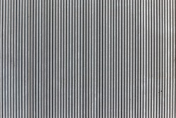 Wavy pattern, corrugated chrome metal sheet background.