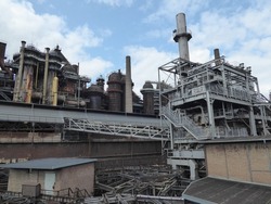 Historic ironworks with blast furnaces, pipes and factory chimneys