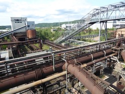 Historic ironworks with blast furnaces, pipes and factory chimneys