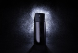 Deodorant in a black metal can on a black background with splashes at the back. Advertising photo of an aerosol antiperspirant. Mocap bottle with spray of water. 3d mockup.