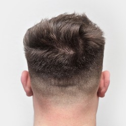 Rear of an attractive young males head after a fresh skin fade haircut.