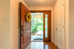Open front door with wreath interior view
