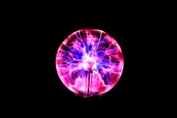 Abstract, blurred image of lightning in a plasma ball. Dark background.
