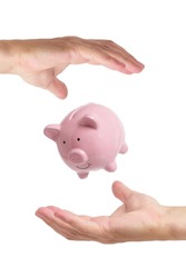 Piggy bank hovering air between two hands