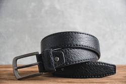 Rolled up black, men leather belt