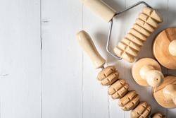 Wood massage maderotherapy madero therapy wooden rolling pin or battledore tools for anti cellulite treatment to stimulate the lymphatic system and improve circulation concept copy space top view