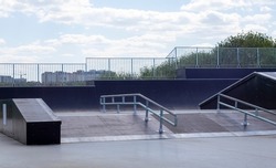 Skate park during the day. Empty, no people skating park. Skatepark ramps