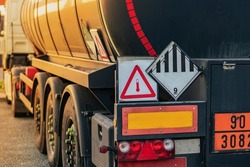 High temperature liquid hazard and miscellaneous hazard label on dangerous goods tank truck.