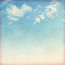White clouds in blue sky in grunge and retro style. 