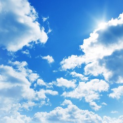 Blue sky with clouds and sun.