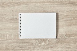 open notepad for notes on a wooden table with a copy space top view