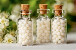 Homeopathy globules in bottles. homeopathy, naturopathy and alternative medicine. Alternative homeopathy medicine concept.