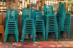Green plastic chairs neatly arranged