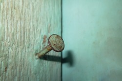Rusty nail stuck in wooden wall                                                            
