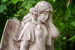 statue of an angel with a broken wing in the old cemetery