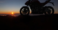 Motorbike parking with sunset background. Biker ride motorcycle. Silhouette of the motobike. Trip and lifestyle motorbike Concept.