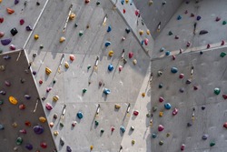 Artificial rock climbing showing various colored grips