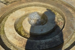 sun-drenched fountain and human shadow