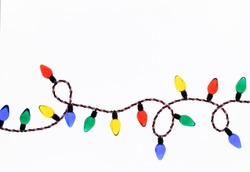 Original Christmas photograph of a string of colorful retro style Christmas tree lights looped across a bright white background