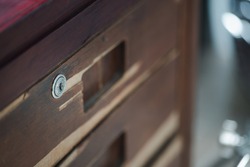 The drawer keyhole represents the old-fashioned old wooden table that has been used for ages.
