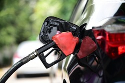 Refueling Car fill with petrol gasoline at  gas station and Petrol pump filling fuel nozzle in fuel tank of car