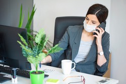 Virus.Woman at the office sick with mask for corona virus. Business women wear masks to protect and take care of their health. Home working with computer. Working from home.
