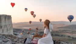 A loving couple among the balloons. A couple in love in Cappadocia. Couple in Turkey. Honeymoon in the mountains. The man and the woman are traveling. Hot air balloon flights. Wedding. Journey. Love