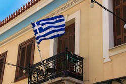 A traditional greek balcony with a greek national flag. Athens - Greece