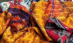 Stunning Indian patchwork quilt in warm red, orange and yellow colours with the traditional Kantha running stitch embroidered from top to bottom