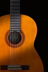 Guitar on black vertical background. Classic acoustic guitar concept. Perfect for flyer, card, poster or wallpaper