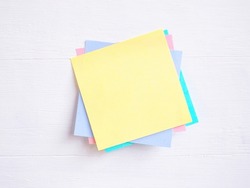 Sticky note ( Post-it) stack on a white wooden. Blank space for text and template for your message.