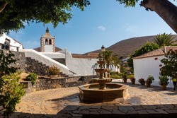Water fountain next to the white church of Betancuria, west coast of the island of Fuerteventura, Canary Islands. Spain