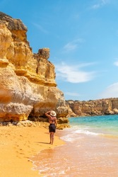 Strolling in summer on vacation on the beach at Praia da Coelha, Algarve, Albufeira. Portugal